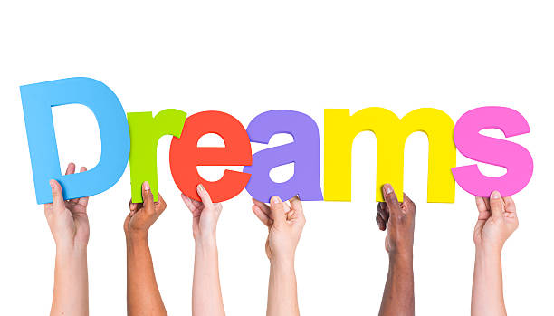 istock Multiethnic Group of Hands Holding Word Dreams 490581139