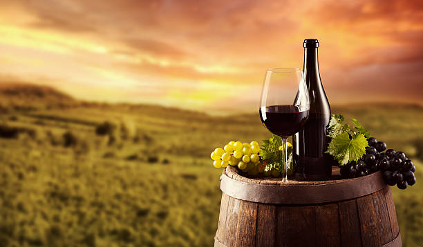istock Red wine bottle and glass on wodden keg 490581158