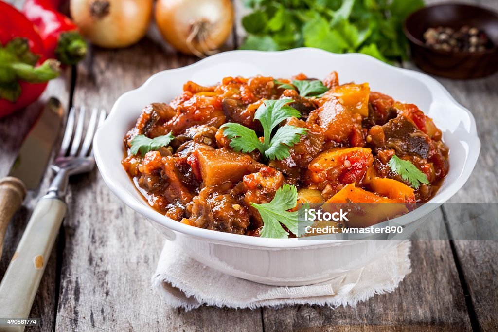 vegetable ragout (ratatouille) paprika, eggplant and tomato vegetable ragout (ratatouille) paprika, eggplant and tomato on wooden table 2015 Stock Photo