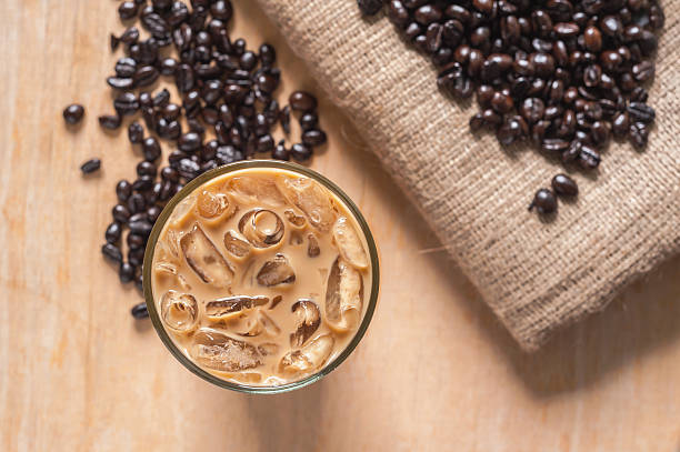 Ice coffee with fresh coffee on wood Ice coffee with fresh coffee on a wooden background iced coffee stock pictures, royalty-free photos & images