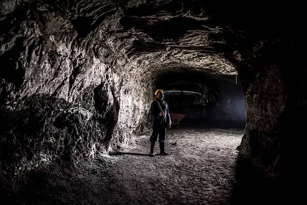 Photo of Miner working at a mine underground