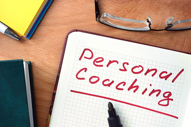 istock Notepad with Personal coaching  on office wooden table. 490583212