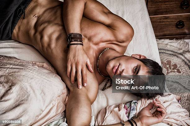 Shirtless Sexy Male Model Lying Alone On His Bed Stock Photo - Download Image Now - Men, Sex Symbol, Shirtless