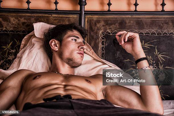 Shirtless Sexy Male Model Lying Alone On His Bed Stock Photo - Download Image Now - 2015, Adult, Adults Only