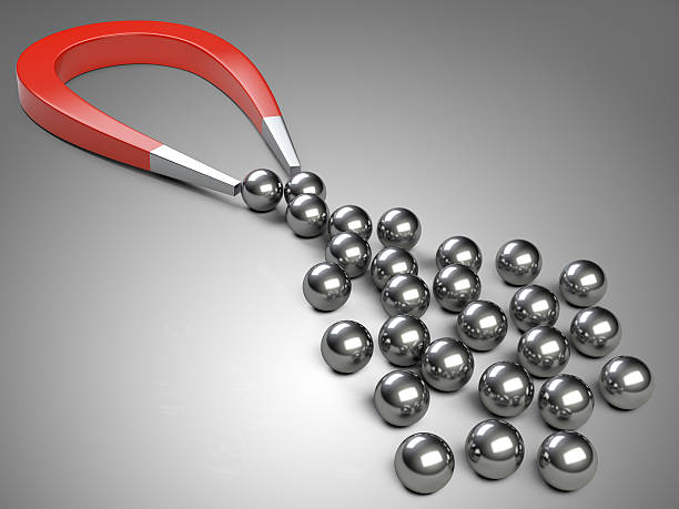 istock Big magnet attracting chrome bearing ball. 490588140