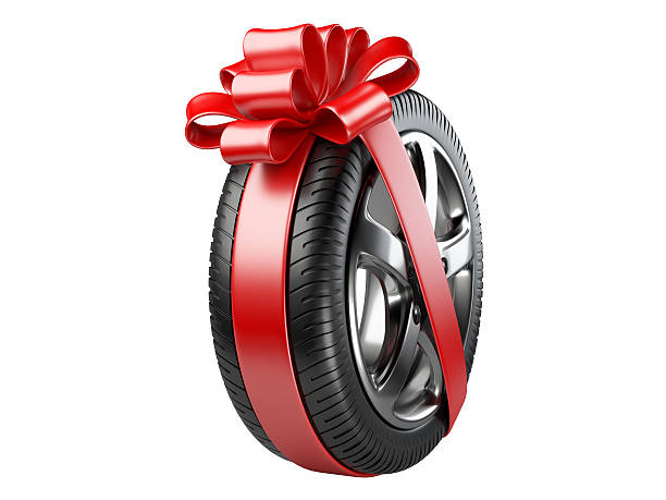 istock tyre with a wrapped red ribbon and bow. 490588448