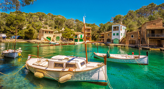 Fishing boat and traditional fishing houses with fishing boat garages in the harbour of Cala Figuera (Santanyí) on the Balearic Islands of Mallorca (Spain).