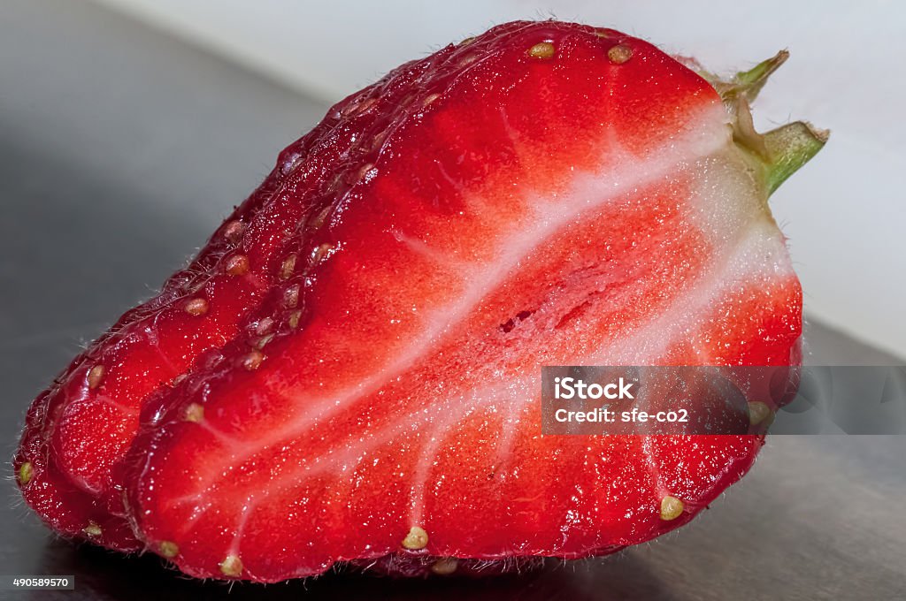 Single sliced strawberry Single sliced strawberry featuring detailed internal and external structures. 2015 Stock Photo