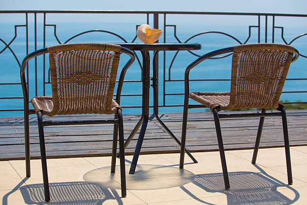 istock chairs and table on terassa by sea 490591174