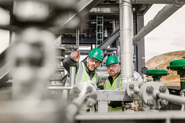 istock Coworkers discussing amidst machinery in industry 490592164