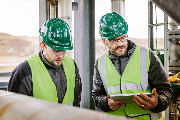 istock Manufacturing workers discussing at factory 490592556