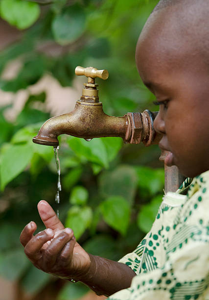 istock Water Scarcity Symbol - African Boy Begs Clean Water 490607056