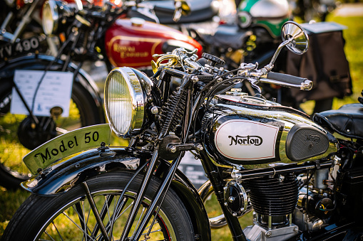 Burlington, Ontario, Canada - September 20, 2015. British Car Day is a classic car show hosted annually by the Toronto Triumph Club at one of the public Parks (Bronte Park) in Burlington (suburbs of Toronto), on the third Sunday of September. Classic Norton motorcycle, parked in the line up old other two wheelers. Since its inaugural event in 1984, it has grown in leaps and bounds, and now draws over 1,000 British cars and 8,000 spectators, with room to grow even bigger. British Car Day is open to vintage, classic and current British manufactured vehicles, including motorcycles. 