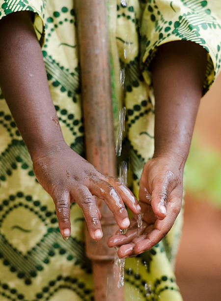 istock Water Spilling on African Hands Scarcity Symbol Drought Thirsty Africa 490607236