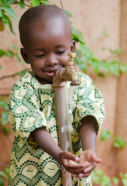 istock Water for the World, Little Black Boy Asking Tap 490607272