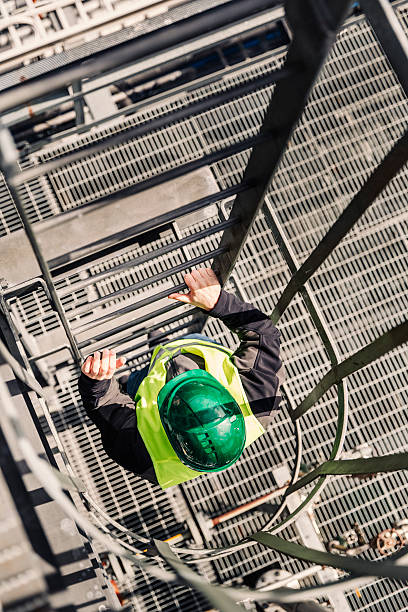 istock Male technician climbing ladder in industry 490607374