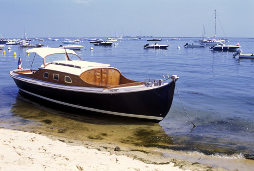 A pretty traditionally built French 'Pinasse' floats calmly at the shore in the Bay of Arcachon, Western France