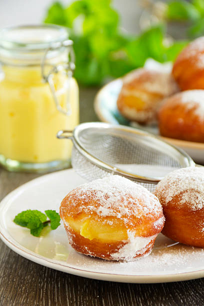 istock With vanilla cream donuts in powdered sugar. 490608755