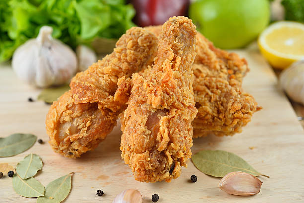 istock fried chicken isolated on wooden  background 490608998