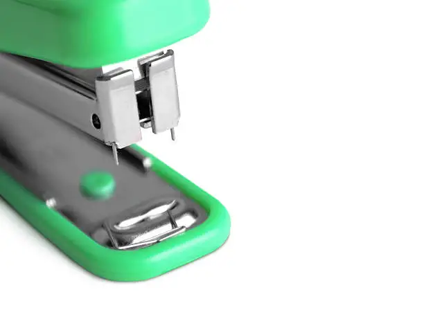 plastic stapler green white background