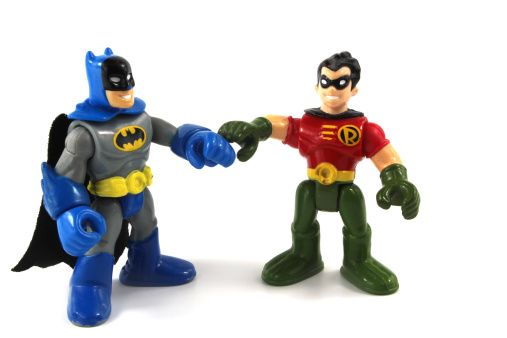 Trowbridge, Wiltshire, UK - May 07, 2014: Photograph of plastic toy figures 'Batman' & 'Robin' from Marvel's 'Super Hero Squad' range. Hasbro began manufacture of the range in 2006. The line features 2-inch scale replicas of comic book heroes from the Marvel Comics universe. The line was designed for younger collectors but has become a hit with fans of all ages despite the \