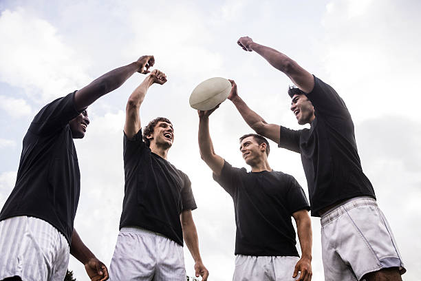 istock Rugby players cheering together with ball 490609752