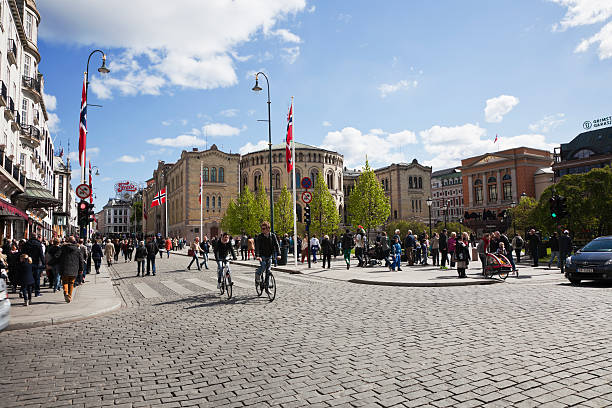 Oslo, Norway - April 1st, 1987: Karl Johans Gate, the main street in Norway\\'s capital, Oslo. Busy street scene with shoppers, tourists and cars with the Royal Palace in the far distance at the end of the road.