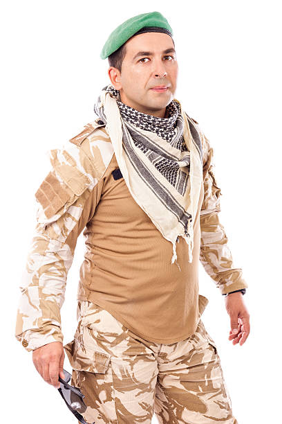 istock Young soldier with green beret and arabian scarf 490611263