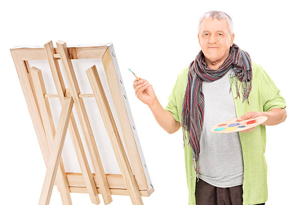 istock Mature artist drawing on an easel 490611615