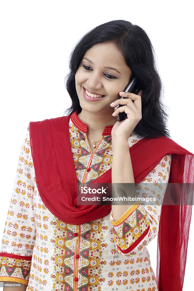 Beautiful young woman talking on mobile phone against white Beautiful young woman talking on mobile phone against white background Adult Stock Photo