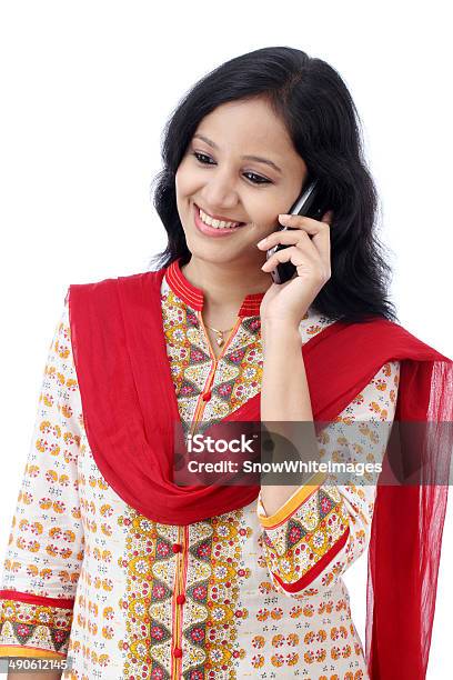 Beautiful Young Woman Talking On Mobile Phone Against White Stock Photo - Download Image Now