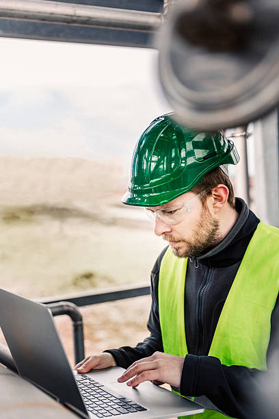 istock Concentrated male professional using laptop in factory 490612242