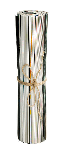 Folded magazine tied with twine Folded magazine tied with twine on a white background rolled up magazine stock pictures, royalty-free photos & images