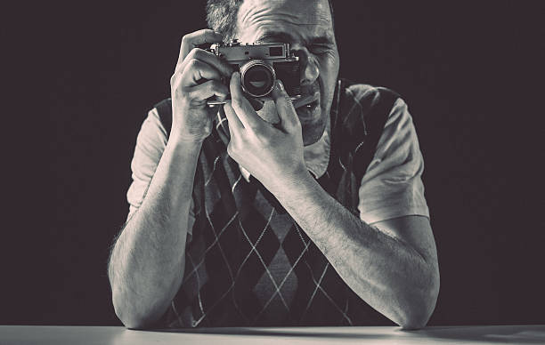 istock Young man taking pictures with vintage camera 490612957