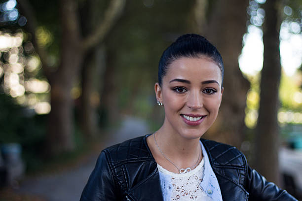 The picture shows the radiant of a beautiful young woman in the autumn light.