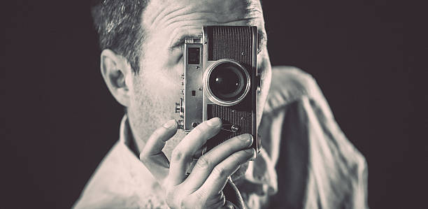 istock Young man taking pictures with vintage camera 490613189
