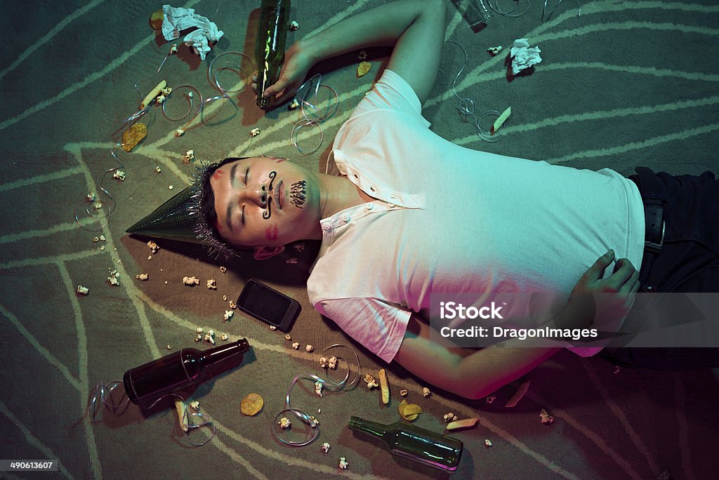 Sleep Man sleeping on the floor after party Drunk Stock Photo