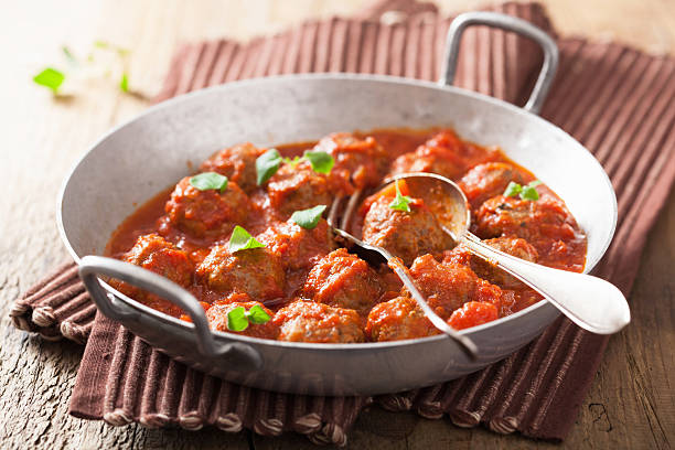 istock meatballs with tomato sauce in pan and spoon 490614739