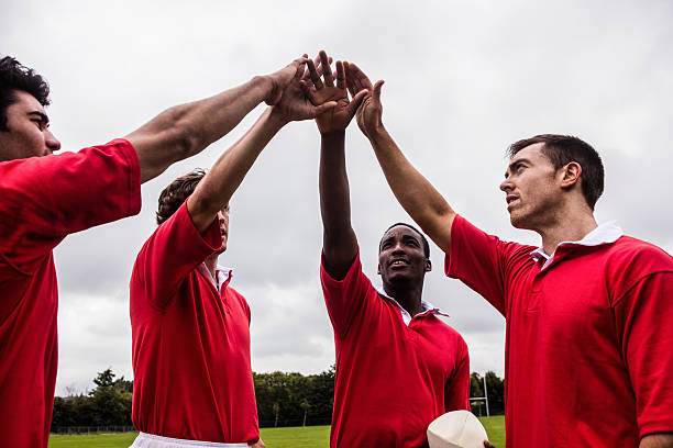 istock Rugby players putting hands together 490615274
