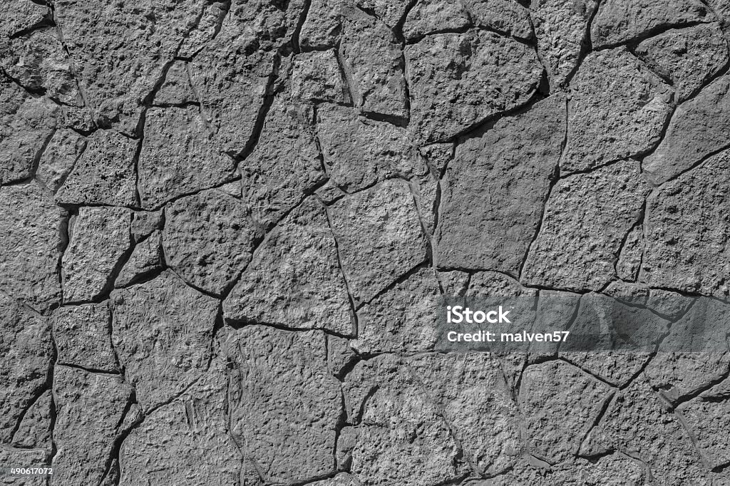 texture of black color stone wall with cracks abstract texture of black color of a stone wall with cracks for empty and pure backgrounds and for wallpaper 2015 Stock Photo