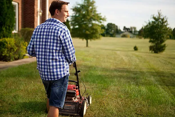 Man takes care of the garden around the house. At Virginia, USA.