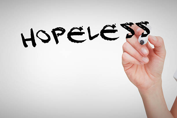 istock Hopeless against female hand holding whiteboard marker 490619254