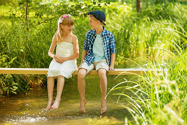 Happy children playing in the river.  Summer holidays on the beach.