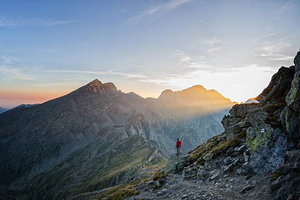 istock Hiker looking over a beatiful valley in the sunset 490620048