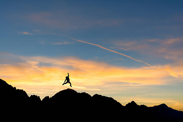istock hiker on the peak at sunset 490620142
