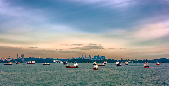 Various cargo ships waiting to load and unload in the harbour at the busiest port of Singapore