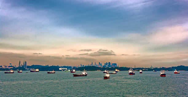 Cargo ships waiting in Singapore Harbour Various cargo ships waiting to load and unload in the harbour at the busiest port of Singapore traffic jam stock pictures, royalty-free photos & images