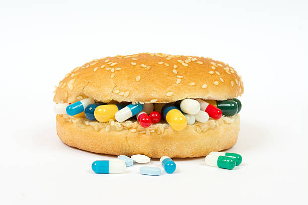 Eating medicines with a sandwich Eating medicines with a sandwich Phobia stock pictures, royalty-free photos & images