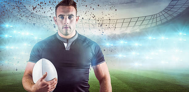 istock Composite image of tough rugby player holding ball 490632148