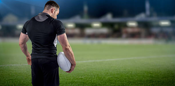 istock Composite image of tough rugby player holding ball 490632516